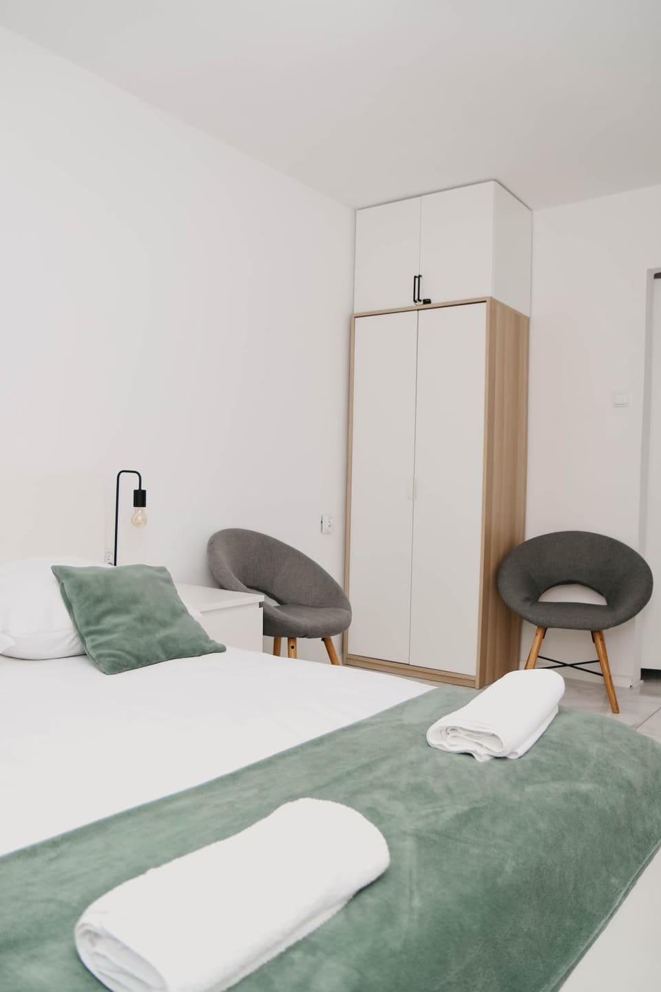 Bed, towels, wardrobe