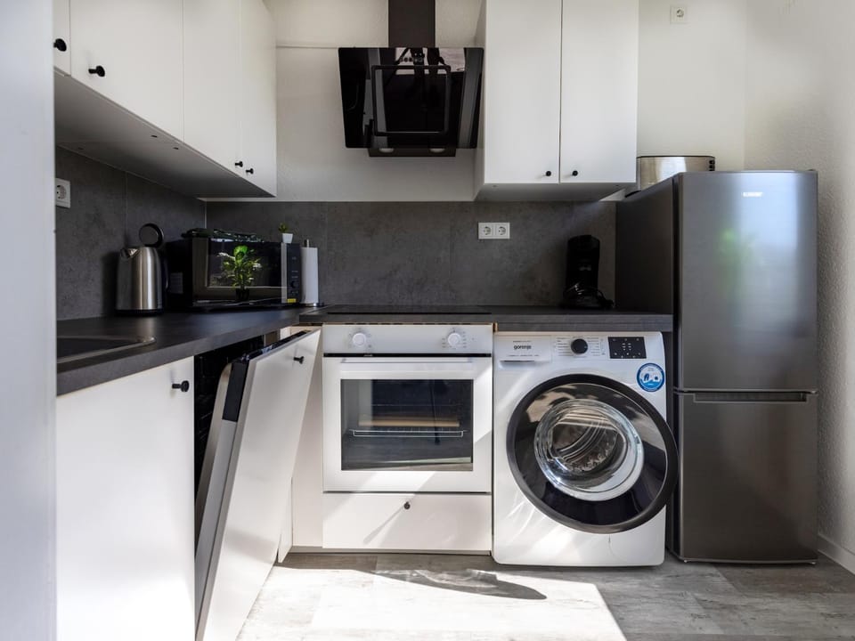 Kitchen or kitchenette, dishwasher, oven, stove, washing machine