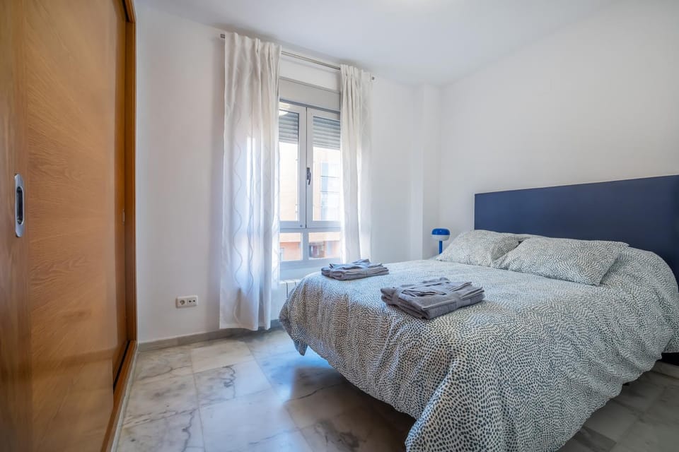 Bed, towels, wardrobe