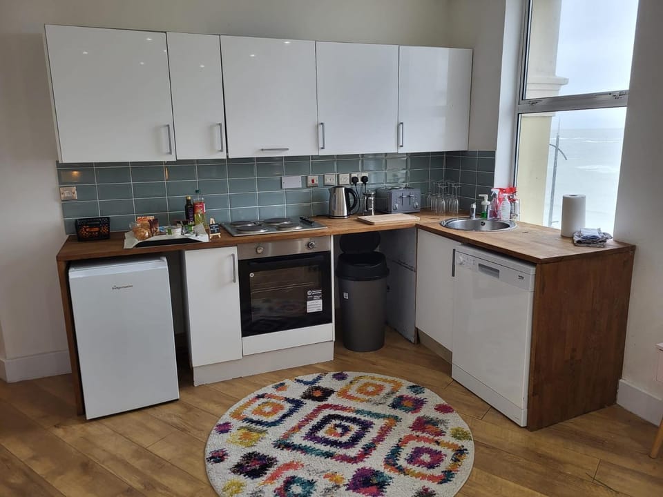 Kitchen or kitchenette, dishwasher, oven, stove, toaster