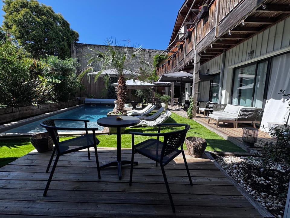 Property building, Patio, Day, Natural landscape, Garden, View (from property/room), Living room, Seating area, Garden view, Pool view, Swimming pool, sunbed