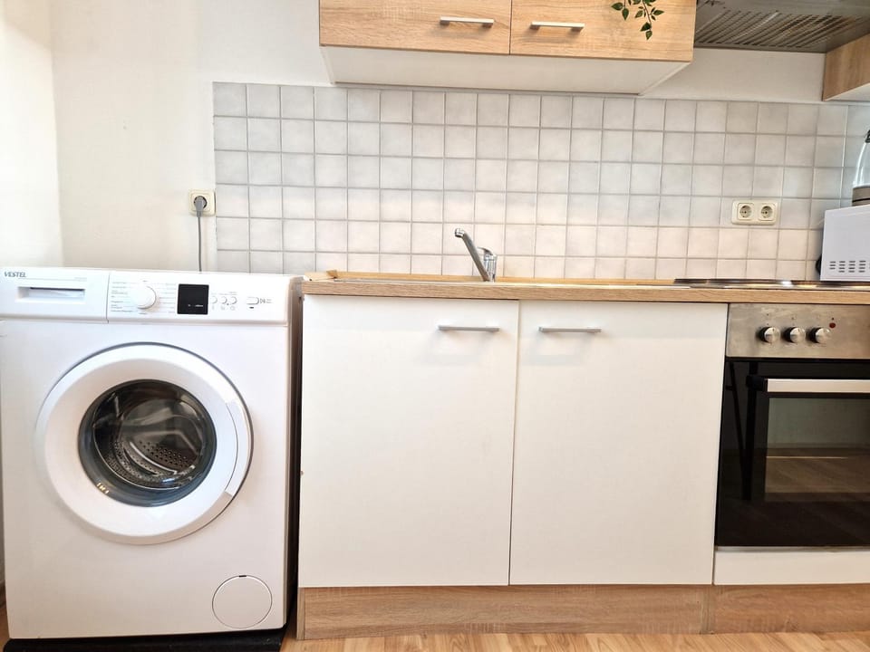 Kitchen or kitchenette, stove, washing machine
