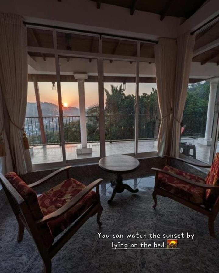 View (from property/room), Living room, Seating area, Evening entertainment, Evening entertainment, Street view, Sunset