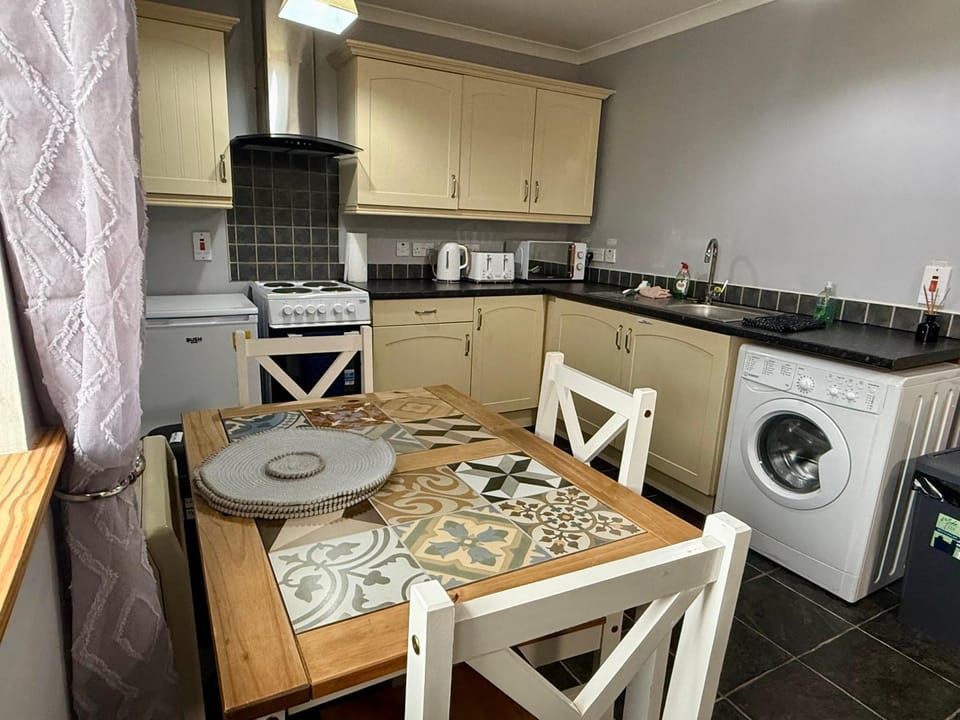 Kitchen or kitchenette, Dining area, oven, stove, toaster, washing machine