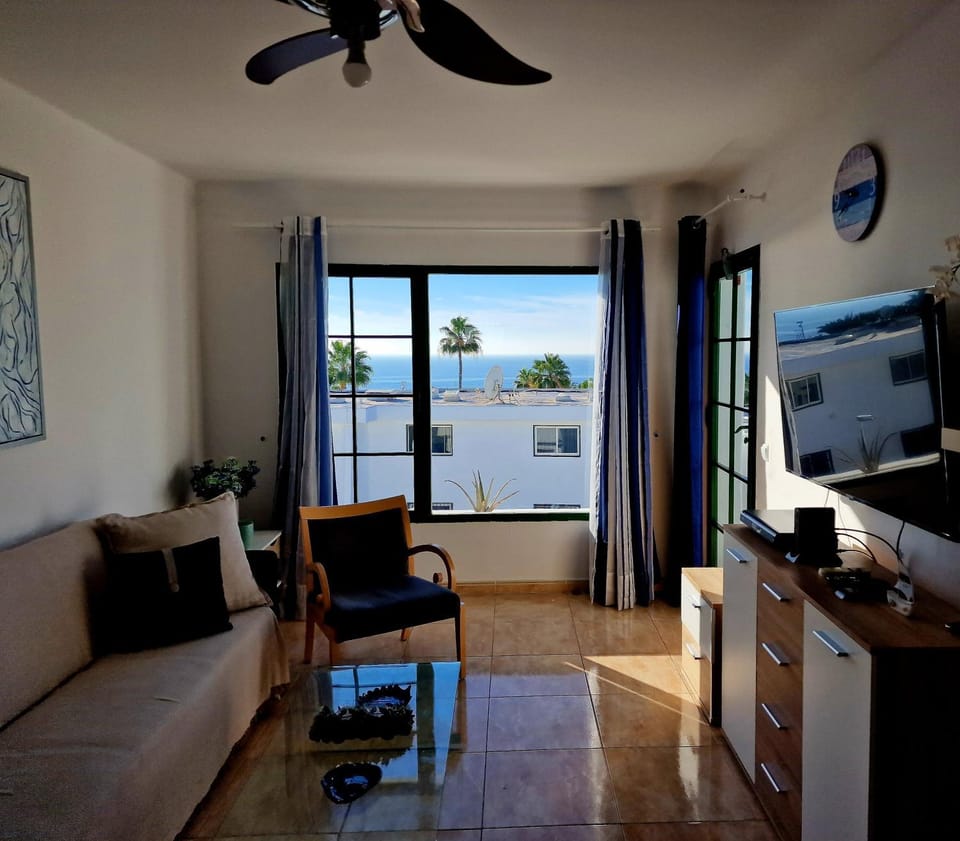 TV and multimedia, View (from property/room), Living room, Seating area, Sea view, fireplace