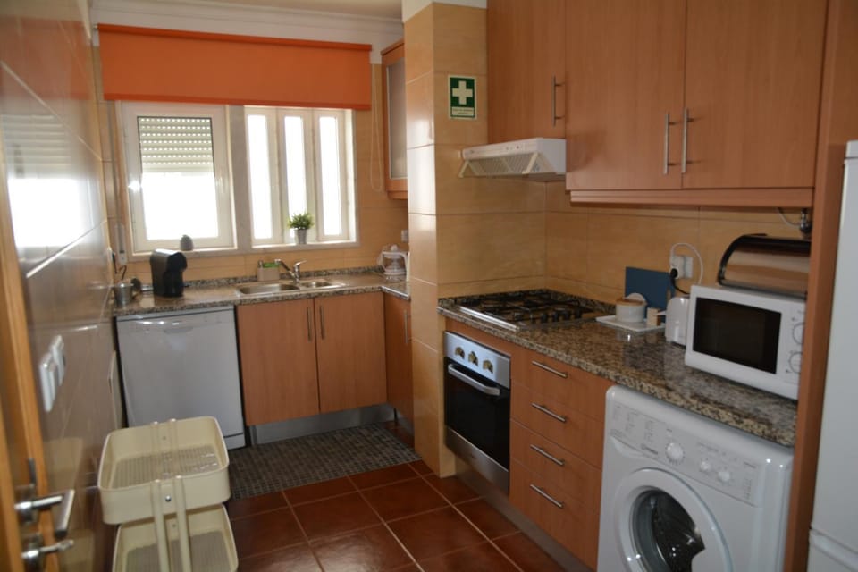 Kitchen or kitchenette, dishwasher, oven, stove, toaster, washing machine