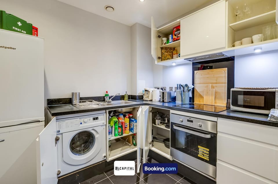 Kitchen or kitchenette, dishwasher, oven, stove, toaster, washing machine