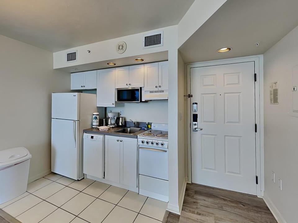 Kitchen or kitchenette, dishwasher, microwave, oven, stove, air conditioner