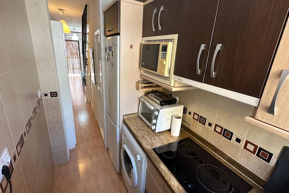 Kitchen or kitchenette, microwave, oven, stove, washing machine