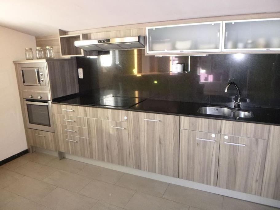 Kitchen or kitchenette, dishwasher, oven, stove