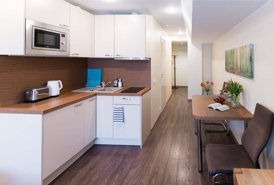 Coffee/tea facilities, Kitchen or kitchenette, Living room, Dining area, furniture, microwave, storage, stove, toaster, wardrobe, kitchen