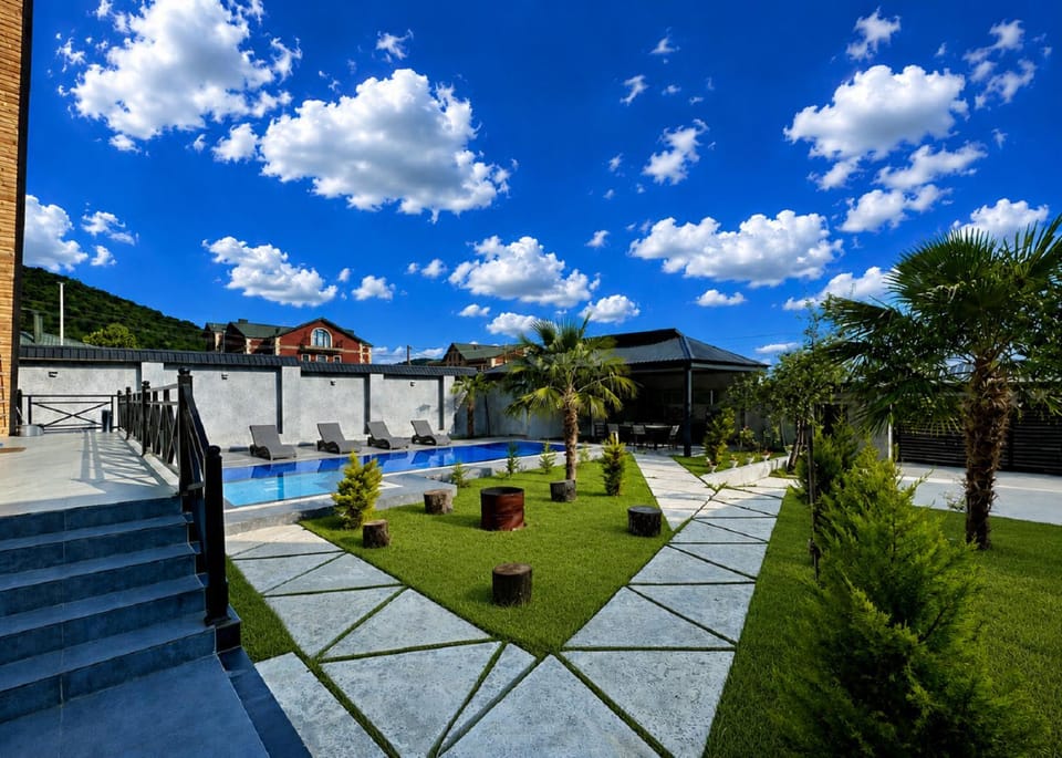 Property building, Patio, Spring, Day, Natural landscape, Garden, Garden view, Pool view, Swimming pool, sunbed