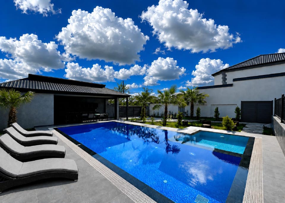 Property building, Patio, Day, Natural landscape, Pool view, Swimming pool, Swimming pool, sunbed