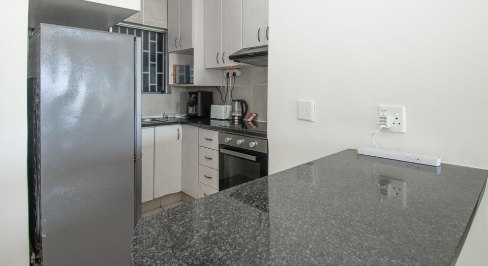 Kitchen or kitchenette, dishwasher, oven, stove