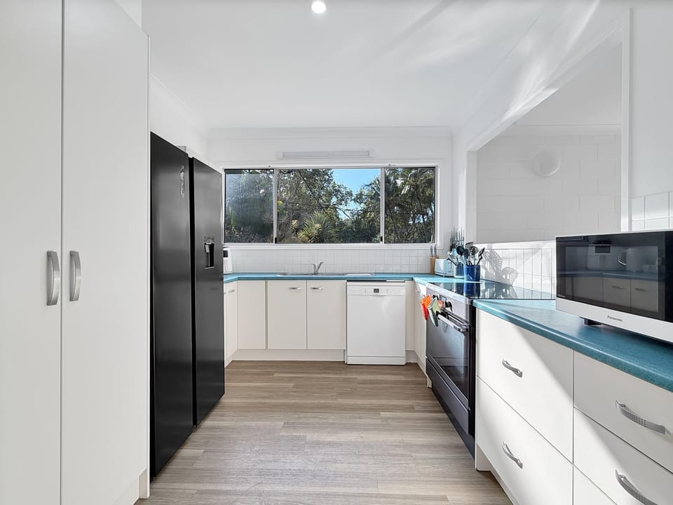 Kitchen or kitchenette, dishwasher, oven, stove