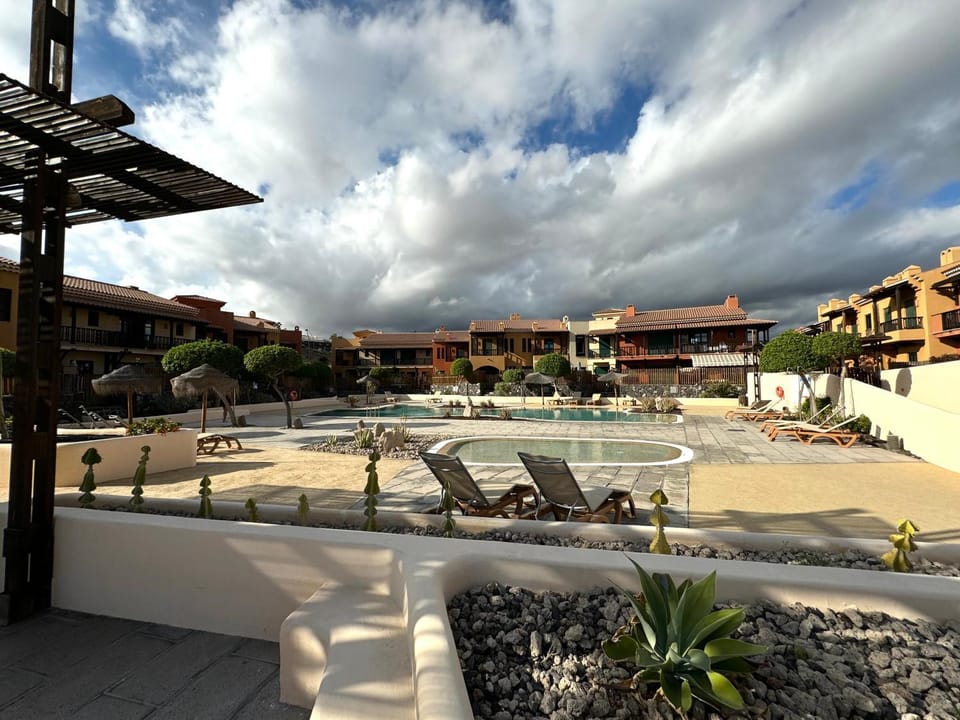 Property building, Patio, Day, Natural landscape, Pool view, Swimming pool, sunbed