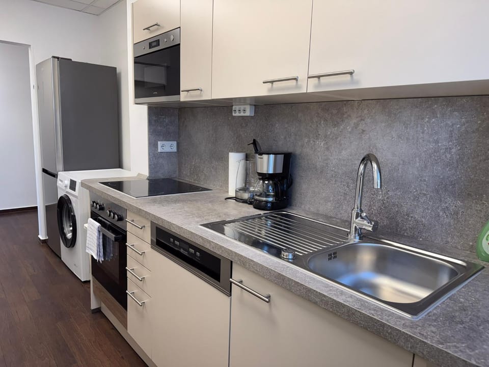 Kitchen or kitchenette, dishwasher, oven, stove