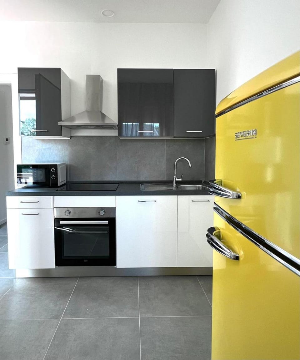 Kitchen or kitchenette, dishwasher, oven, stove