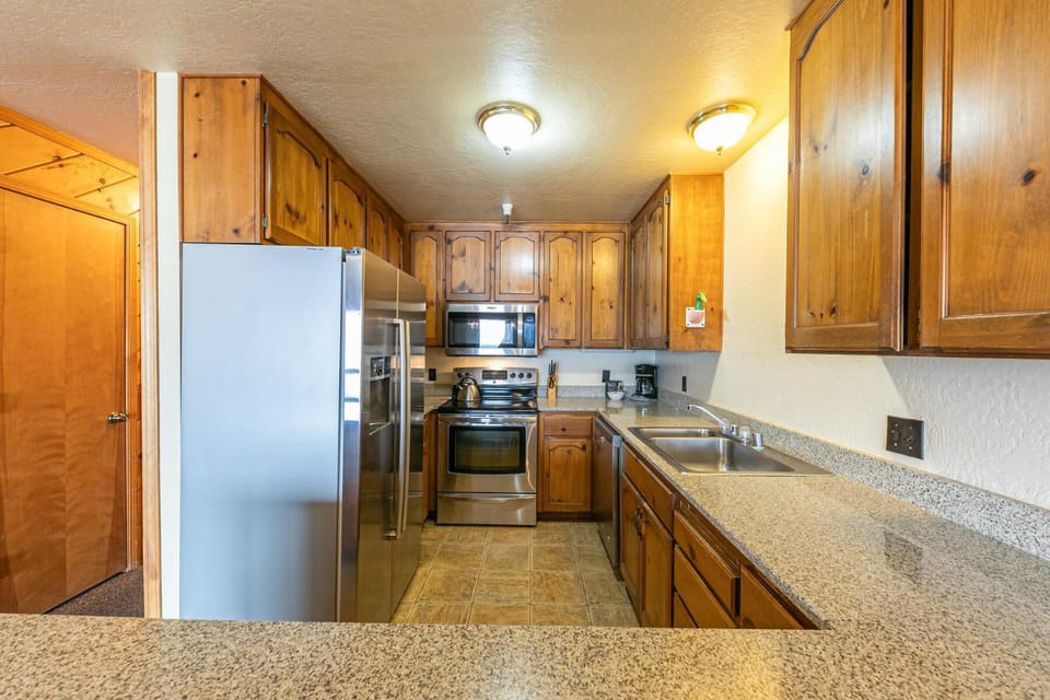 Kitchen or kitchenette, dishwasher, oven, stove
