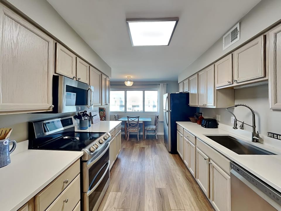 Kitchen or kitchenette, dishwasher, furniture, microwave, oven, stove