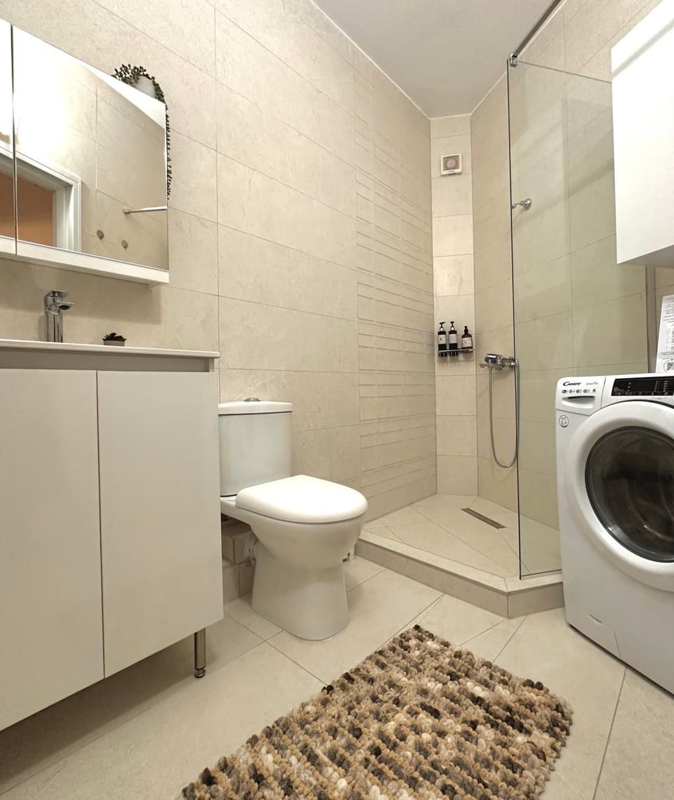 Shower, Toilet, Bathroom, towels, washing machine, dryer