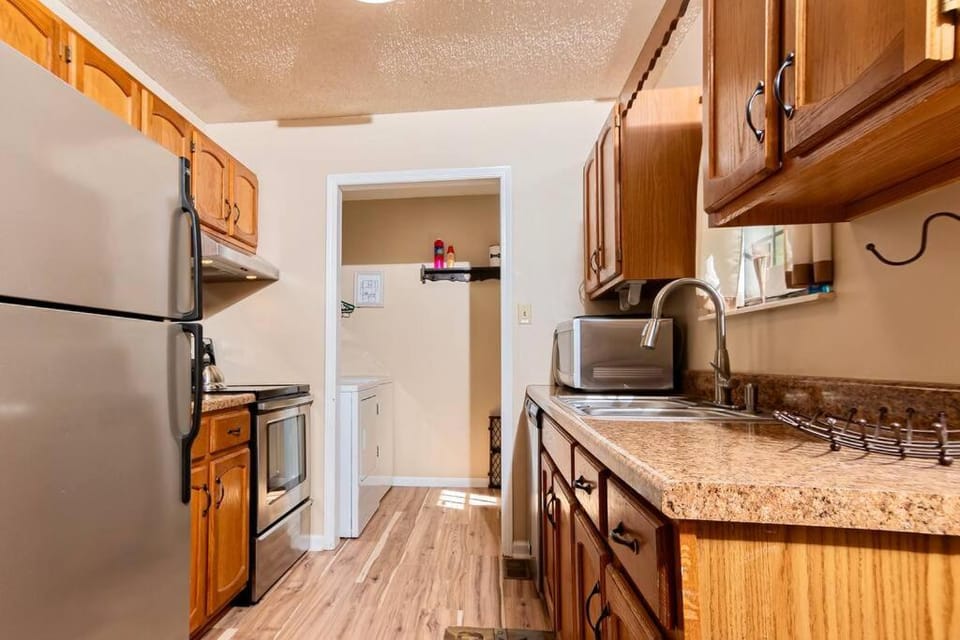 Kitchen or kitchenette, dishwasher, oven, stove