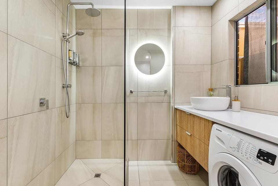 Shower, Toilet, Bathroom, hair dryier, towels, washing machine