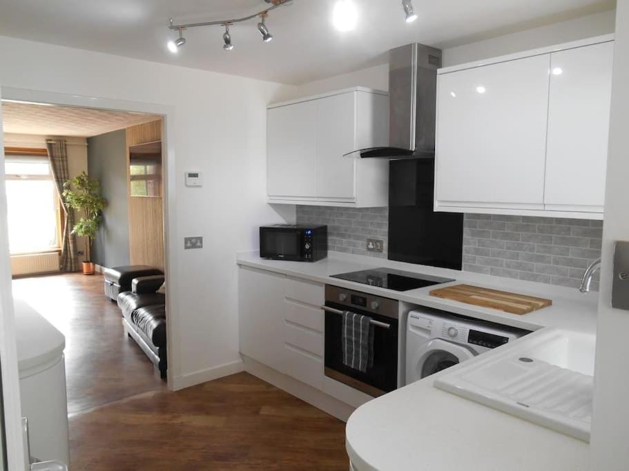 Kitchen or kitchenette, dishwasher, oven, stove