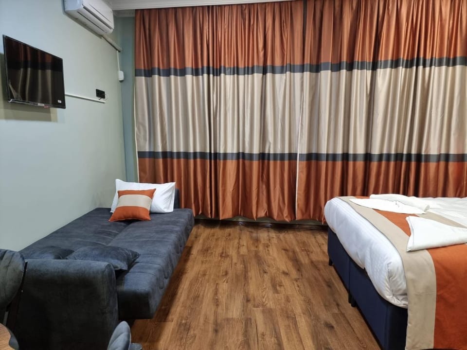 Bed, TV and multimedia, Living room, Seating area, Bedroom, air conditioner