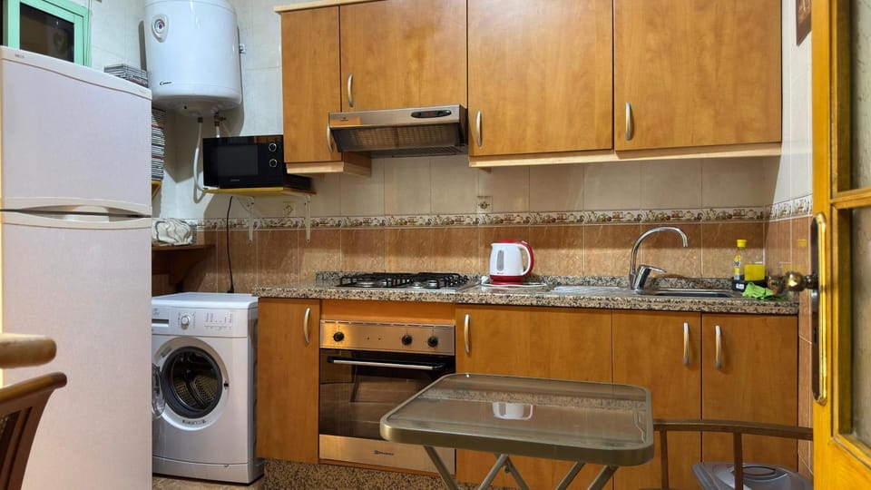 Kitchen or kitchenette, stove, washing machine