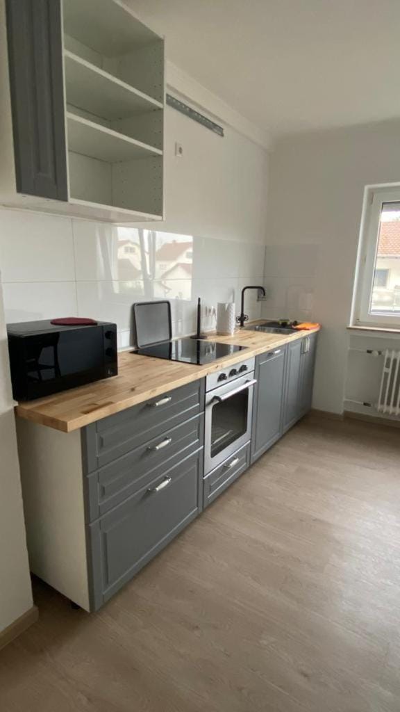 Kitchen or kitchenette, dishwasher, oven, stove