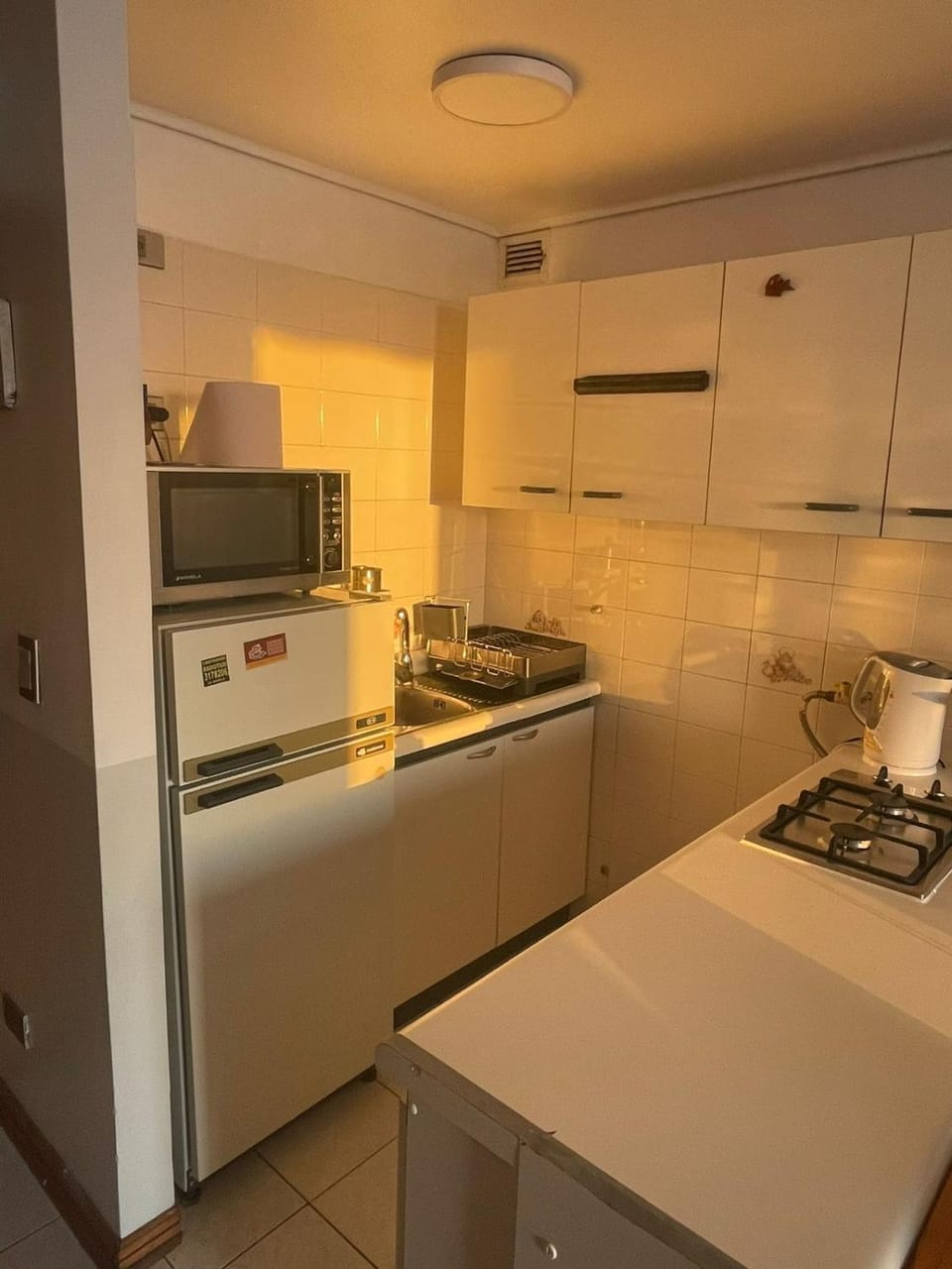 Kitchen or kitchenette, microwave, stove, toaster