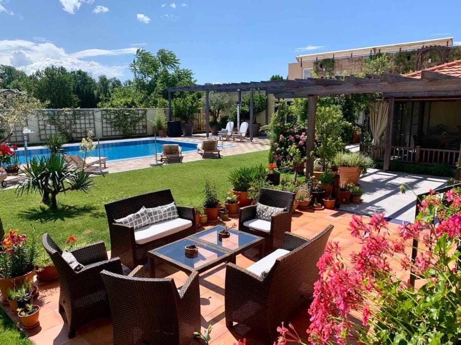 Property building, Patio, Spring, Seating area, Garden view, Pool view, Swimming pool, sunbed