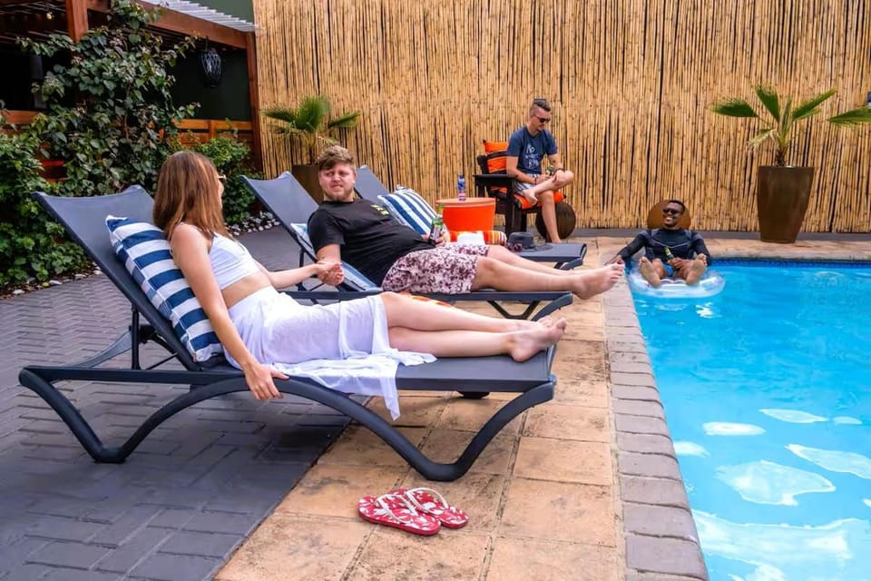 Patio, People, Seating area, Swimming pool, sunbed
