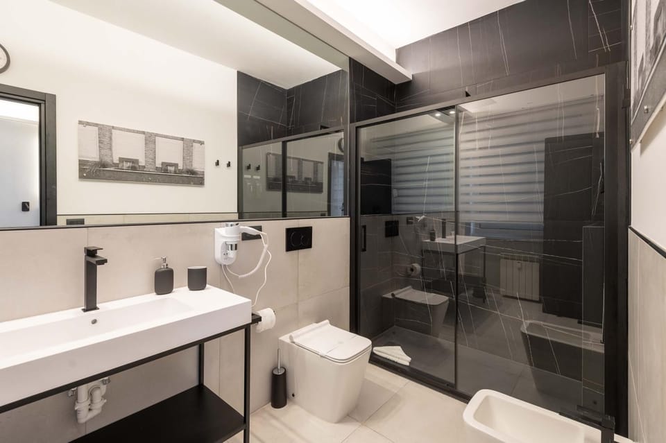 Shower, Toilet, Bathroom, bidet, hair dryier, towels, air conditioner