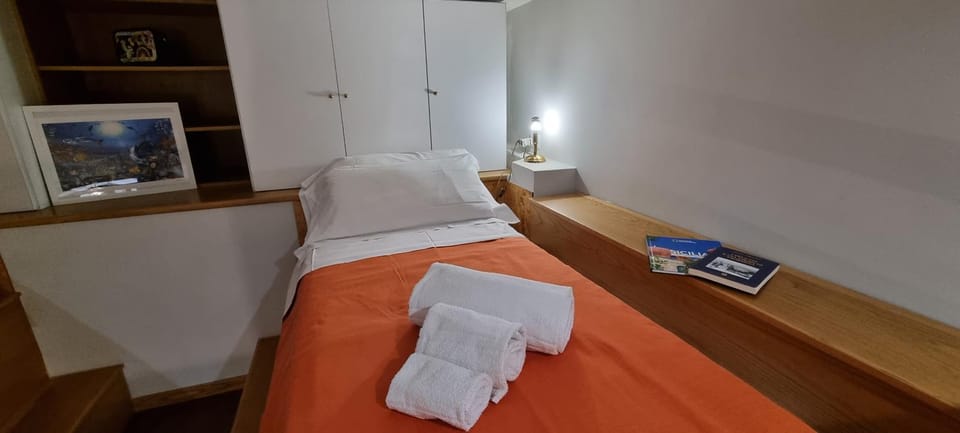 Bed, towels, wardrobe