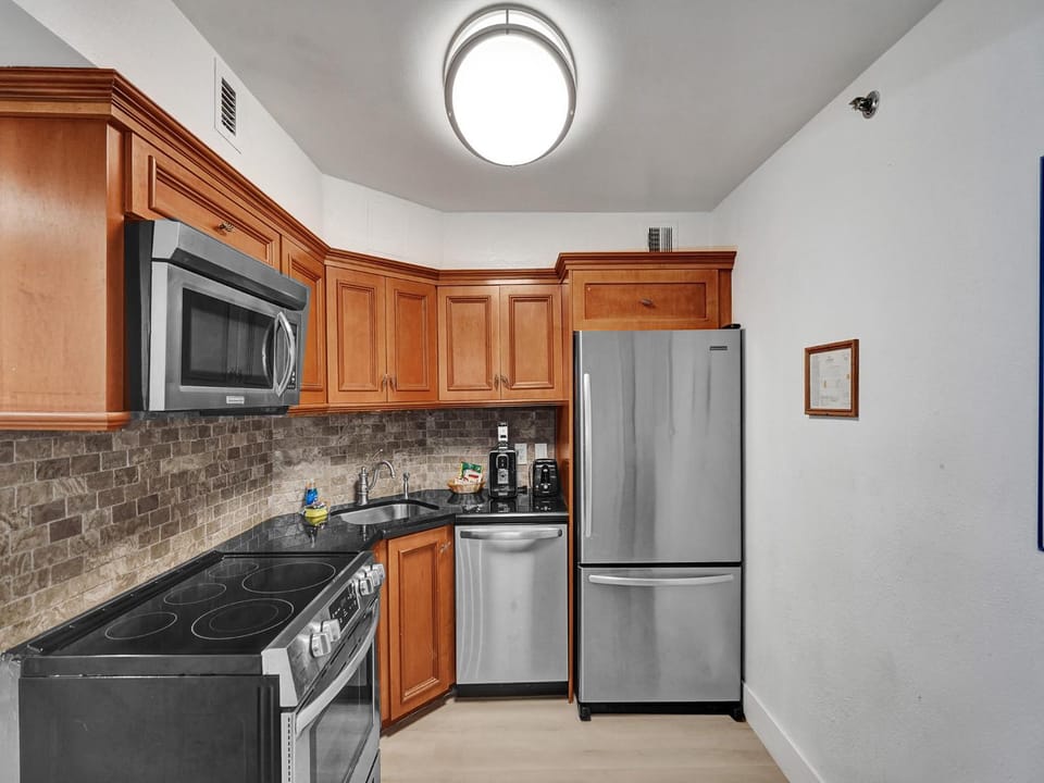 Kitchen or kitchenette, dishwasher, oven, stove