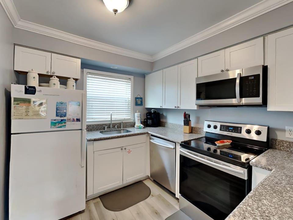 Kitchen or kitchenette, dishwasher, furniture, microwave, oven, stove
