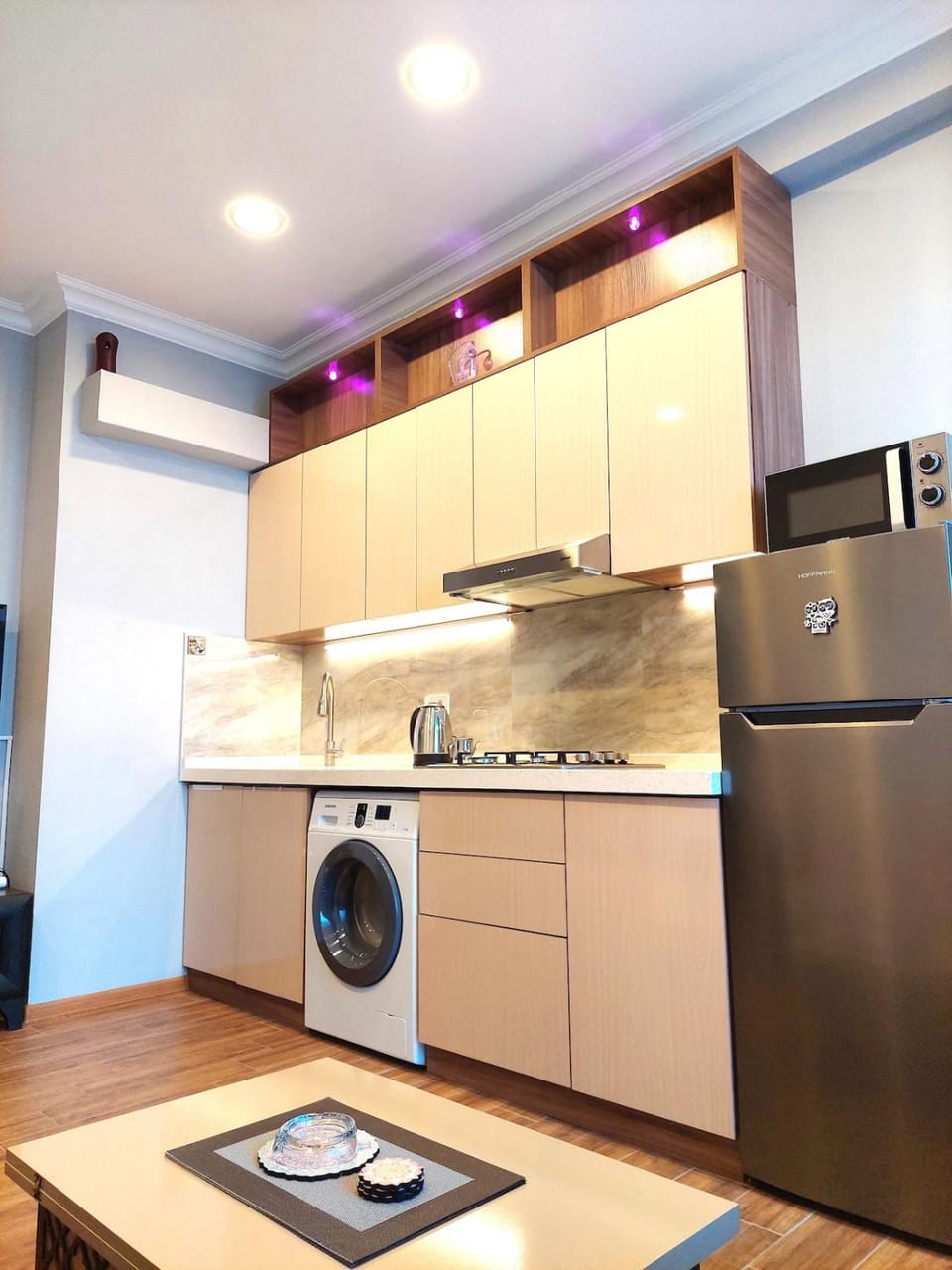 Kitchen or kitchenette, microwave, stove, washing machine