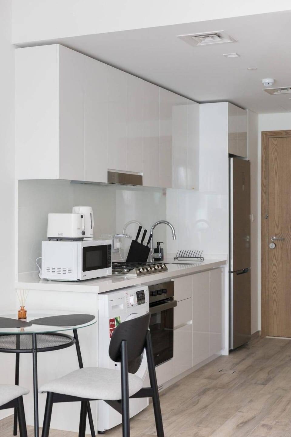Kitchen or kitchenette, microwave, oven, stove, toaster, washing machine