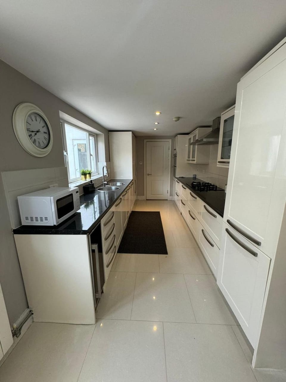 Kitchen or kitchenette, dishwasher, oven, stove
