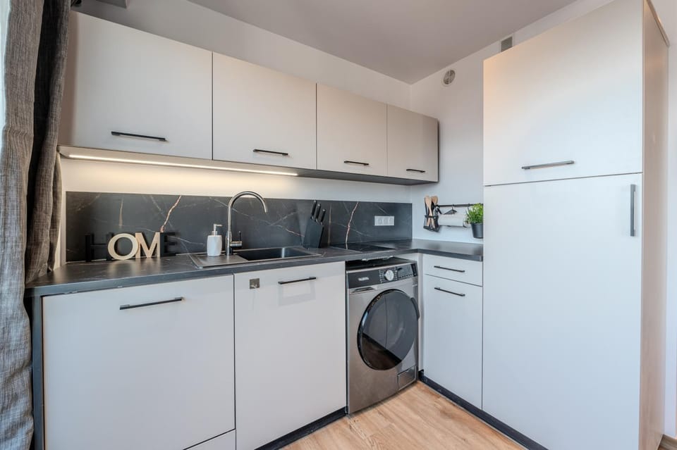 Kitchen or kitchenette, dishwasher, stove, toaster, washing machine