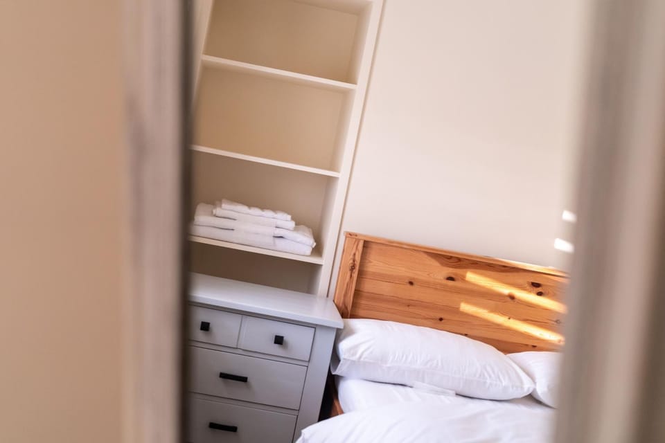 Bed, towels, wardrobe