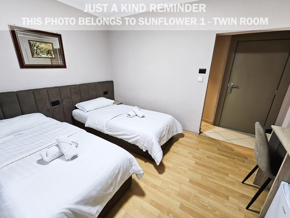 Bed, Photo of the whole room, Bedroom, Text overlay, towels