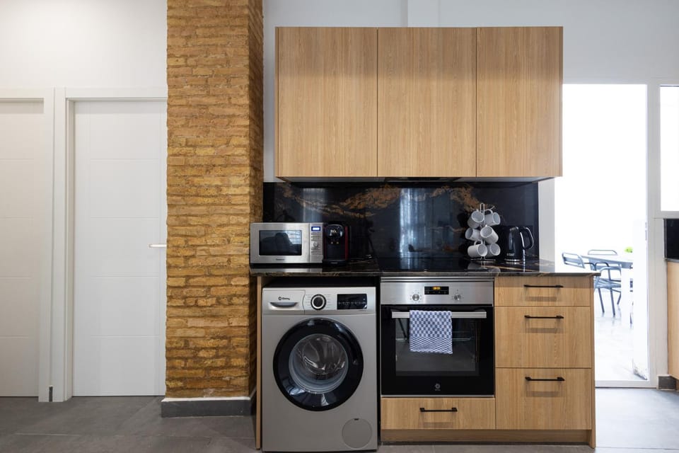Kitchen or kitchenette, dishwasher, oven, stove, toaster, washing machine