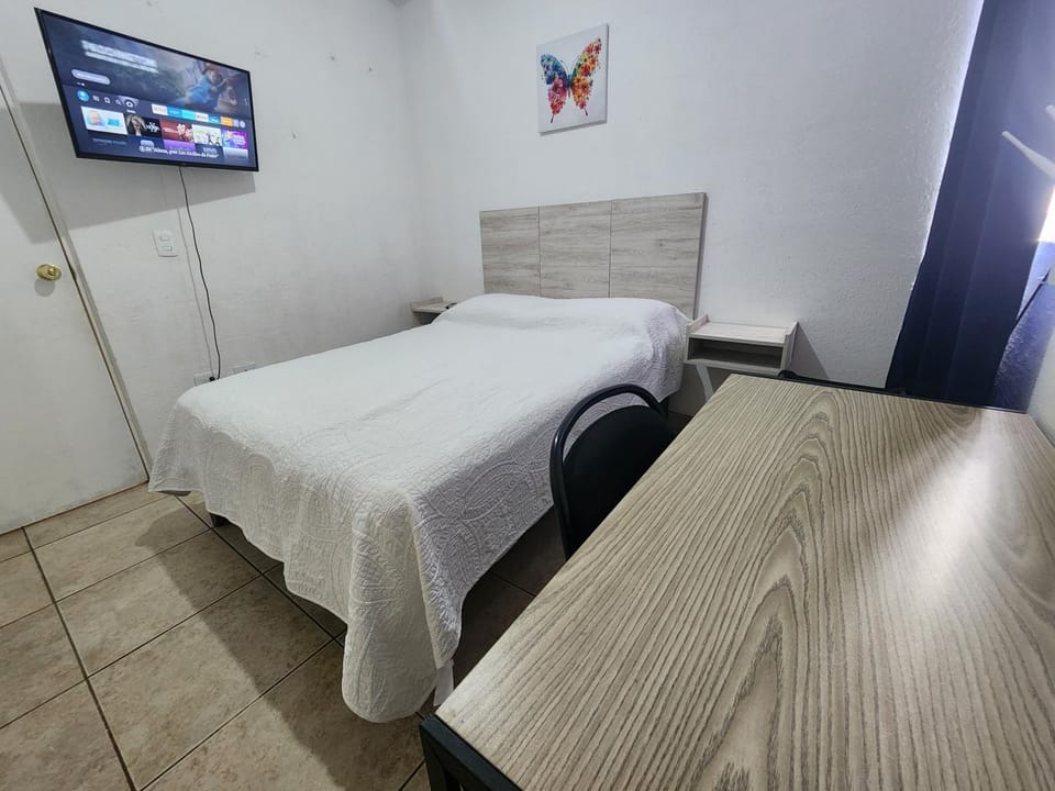 Bed, TV and multimedia, Seating area, wardrobe, air conditioner