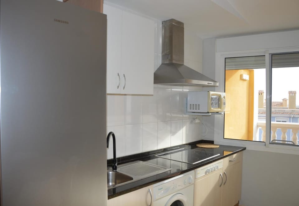 Kitchen or kitchenette, flat iron, microwave, stove, toaster