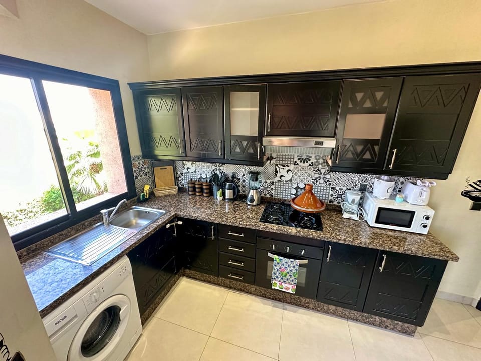 Kitchen or kitchenette, oven, stove, washing machine