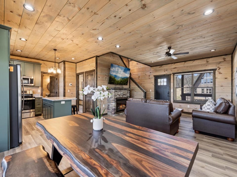 TV and multimedia, Kitchen or kitchenette, Living room, Seating area, fireplace, furniture, microwave, kitchen, air conditioner