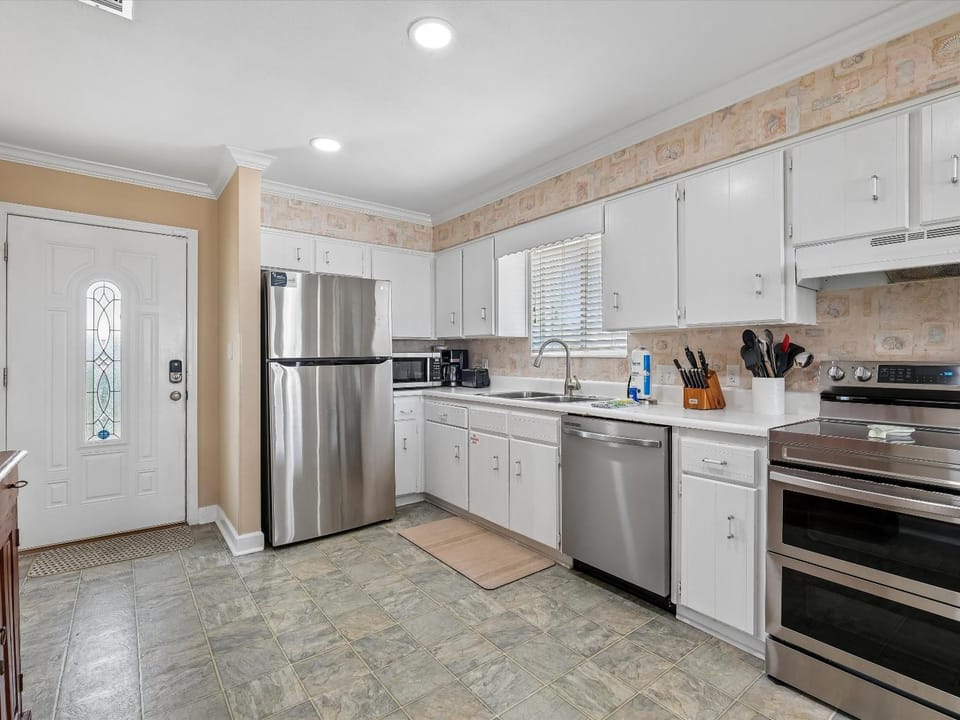 Kitchen or kitchenette, dishwasher, microwave, oven, stove, towels, kitchen